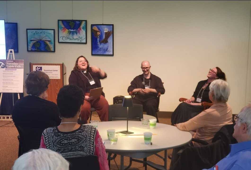 Panelists laughing together at a Tuesday Table Talk